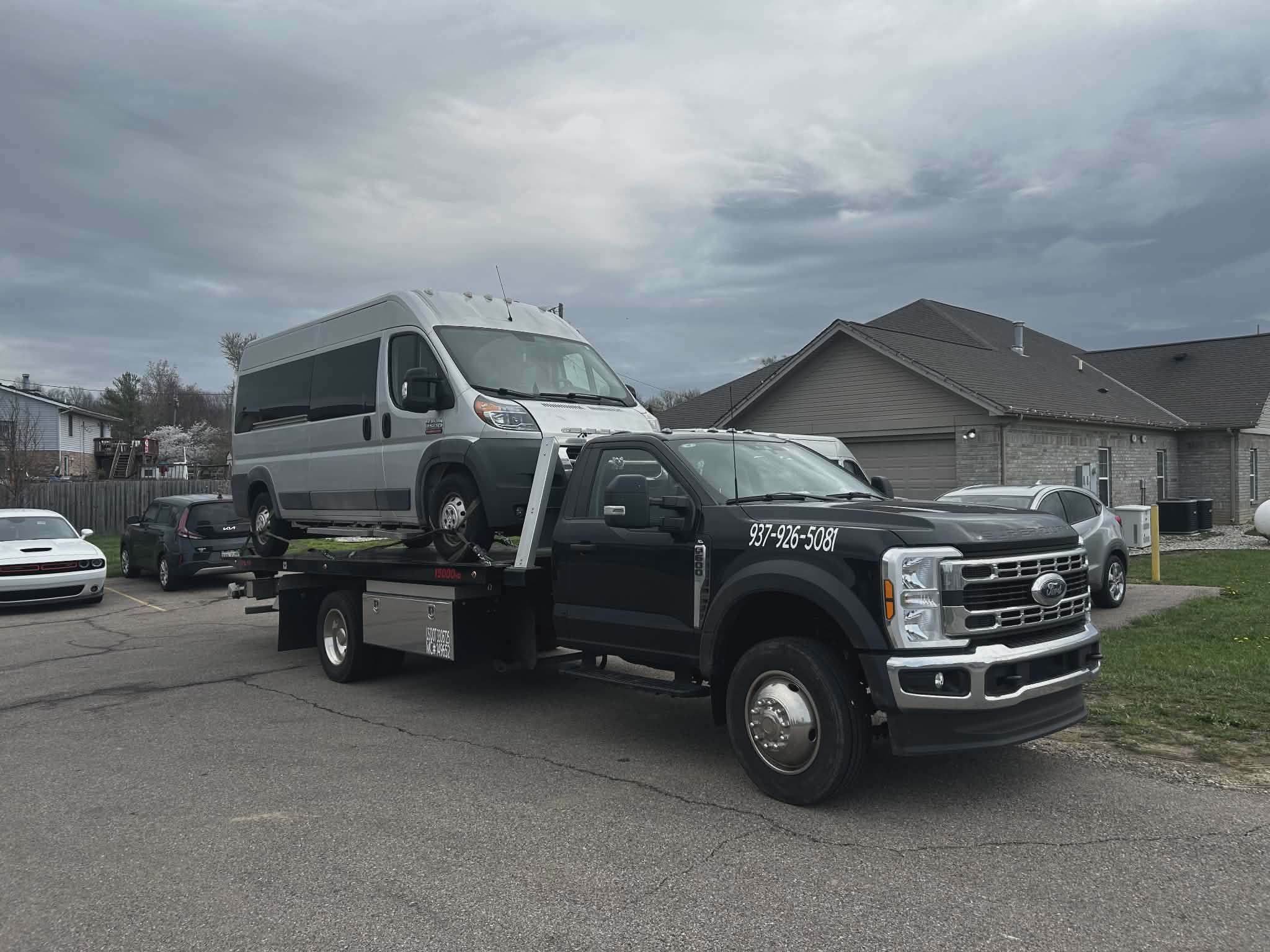 Rudd's flatbed tow truck hauling a passenger van